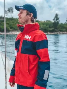 Man in a sailing jacket on sailboat cruising in Croatia